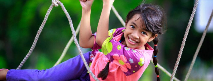 Happy little asian girl on the playground